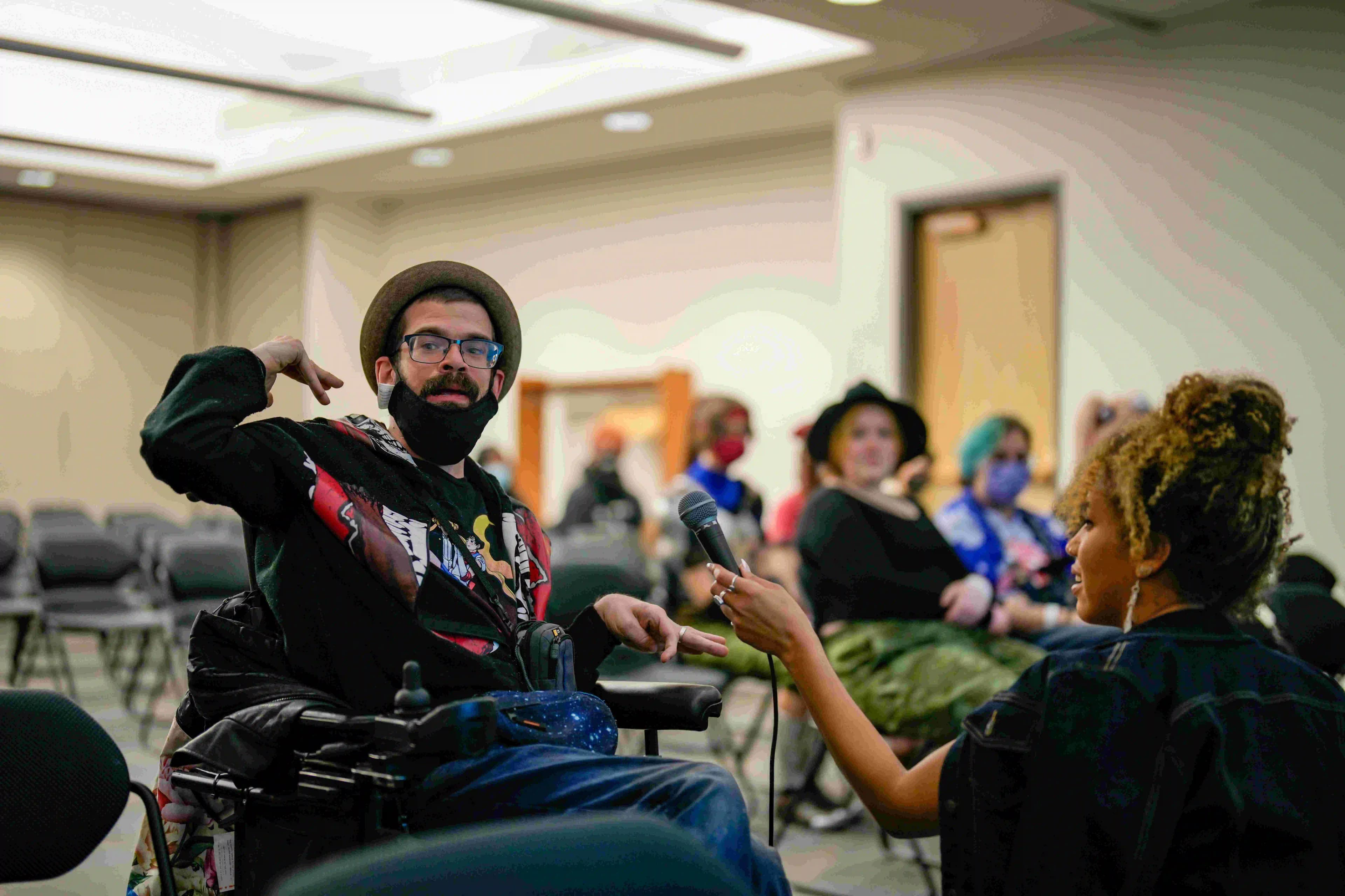 A group of people with disabilities smiling and looking at the camera.